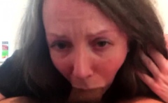 Hot brunette milf with big boobs gives a blowjob