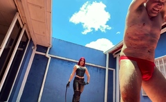 Hot sadistic mistress in leather bullwhips her slave