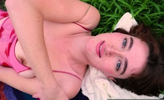 Busty hottie fingers her hairy pussy in the garden